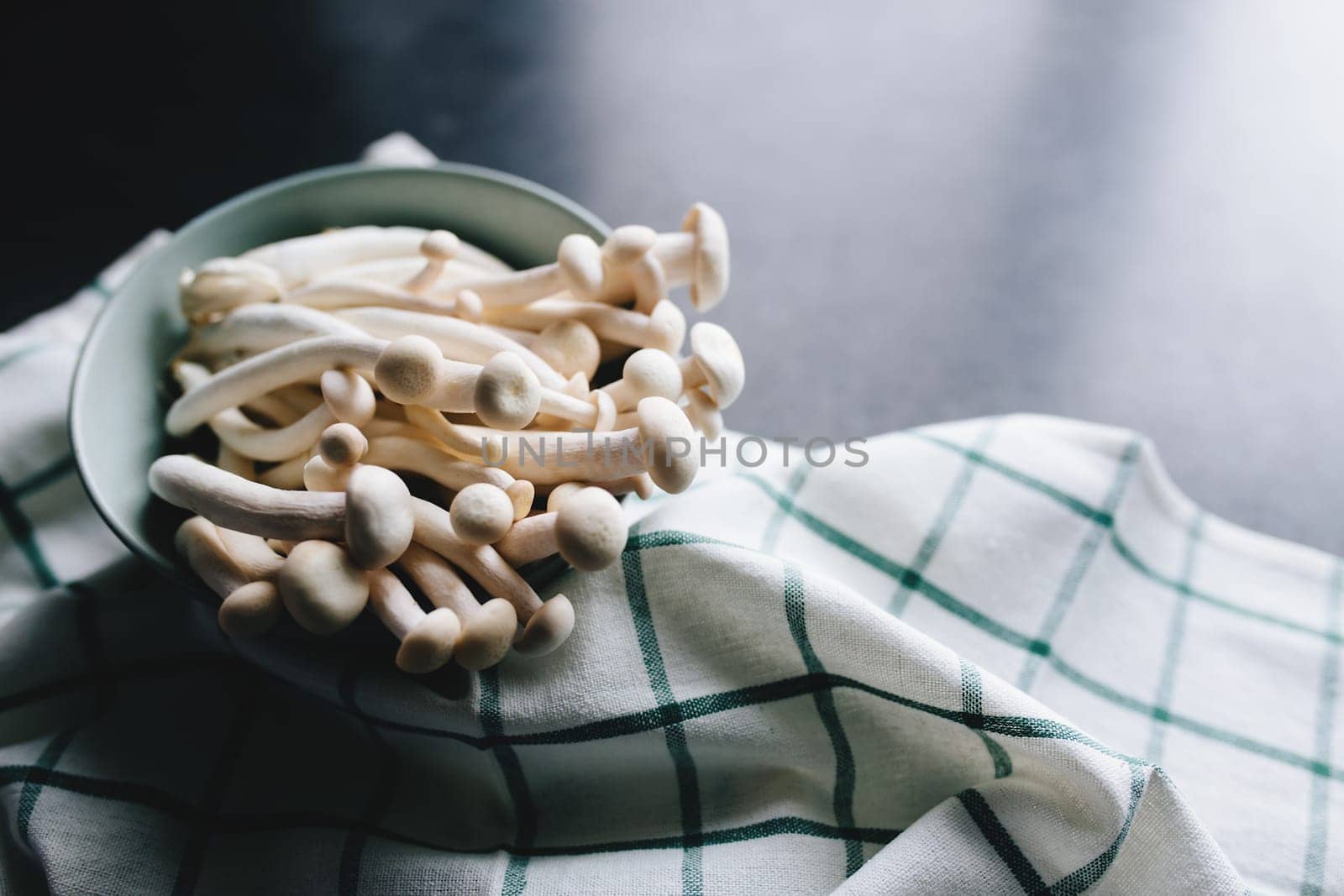 Cooking white mushrooms on the dark gray background. High quality photo