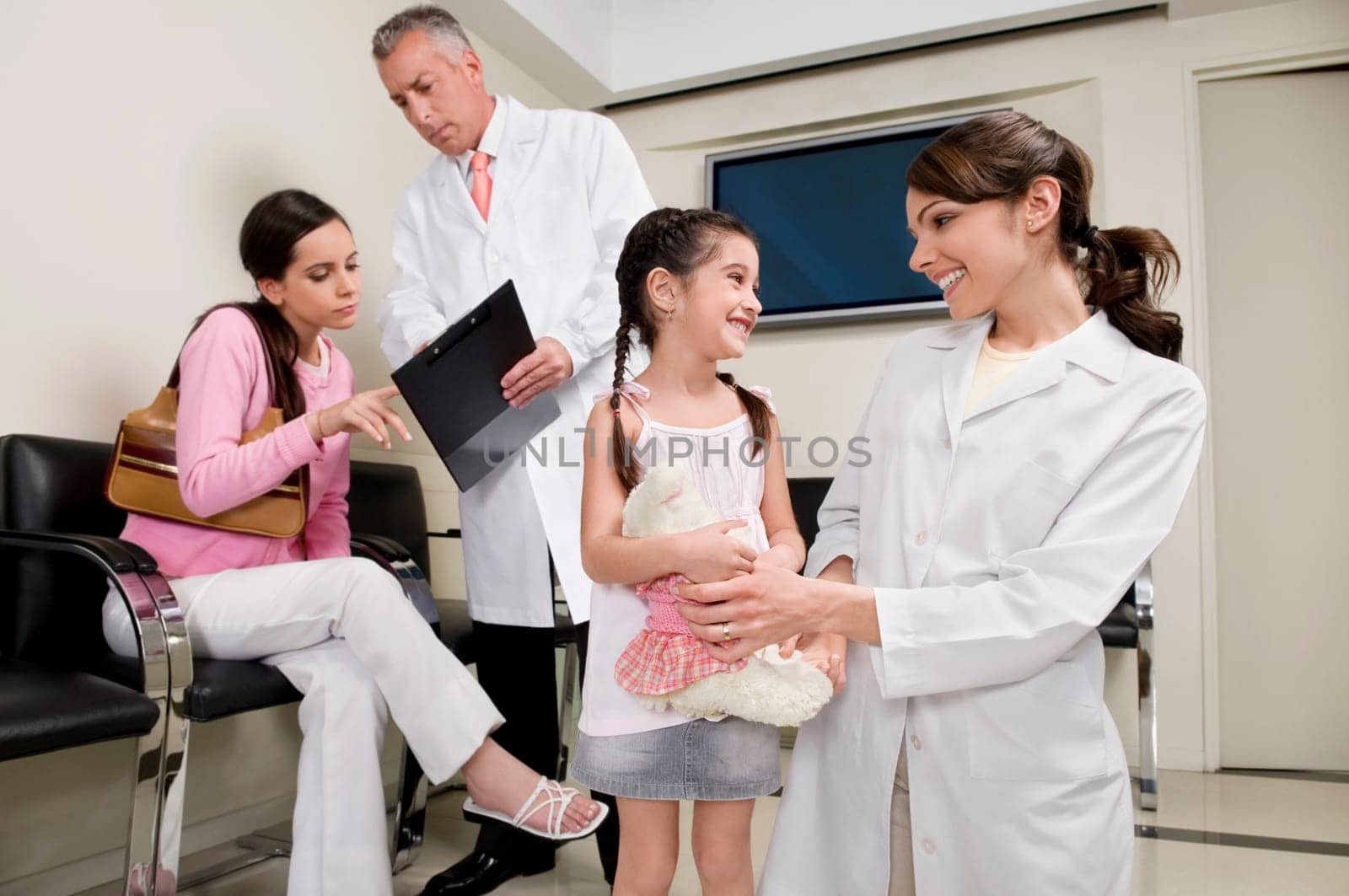 Male and a female doctor with patients
