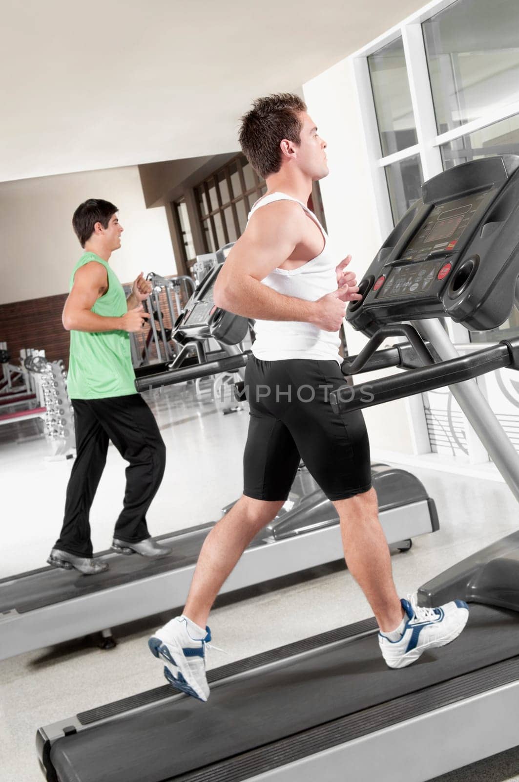 Two men running on treadmills