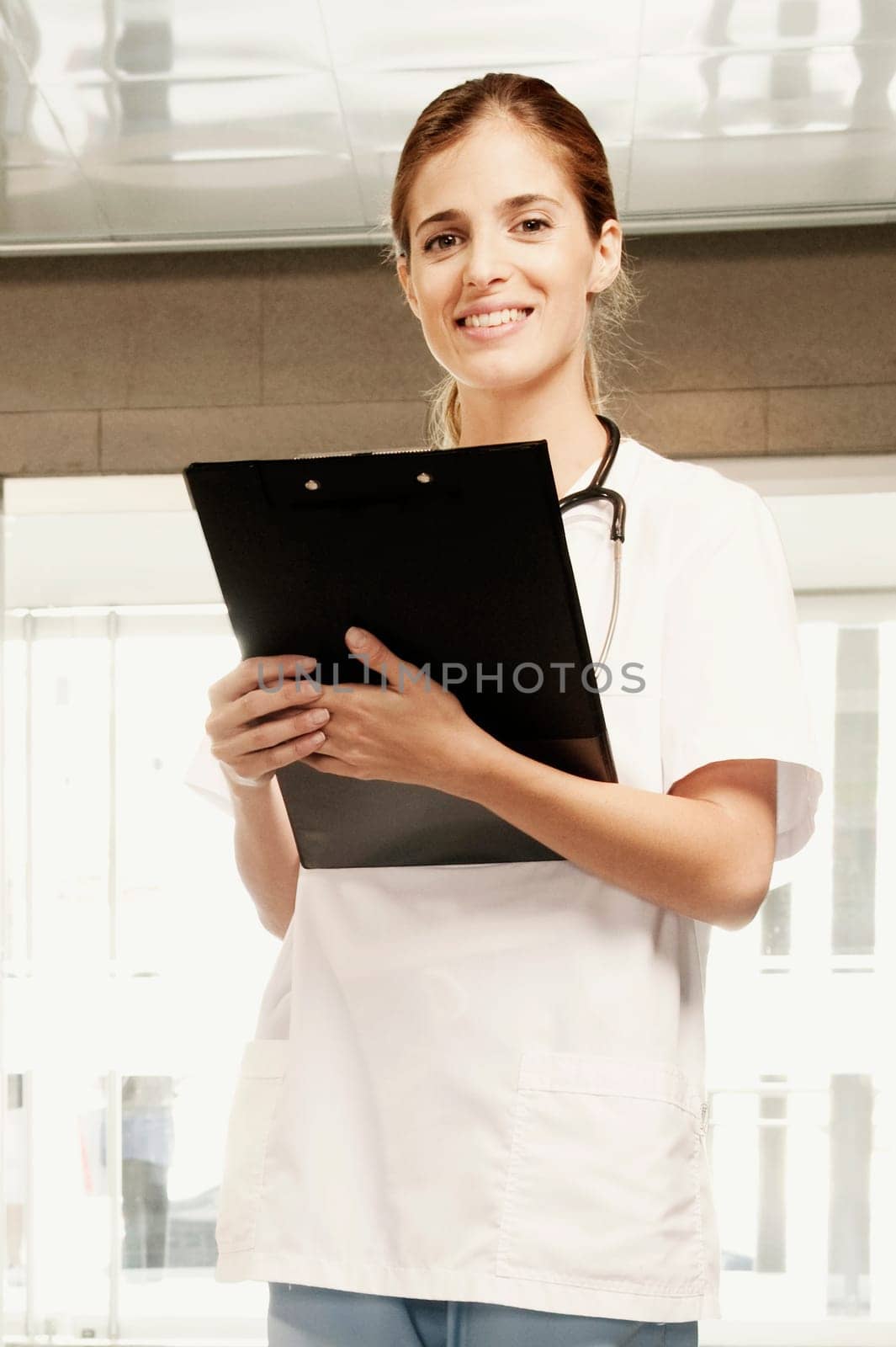 Portrait of a female doctor holding a clipboard and smiling