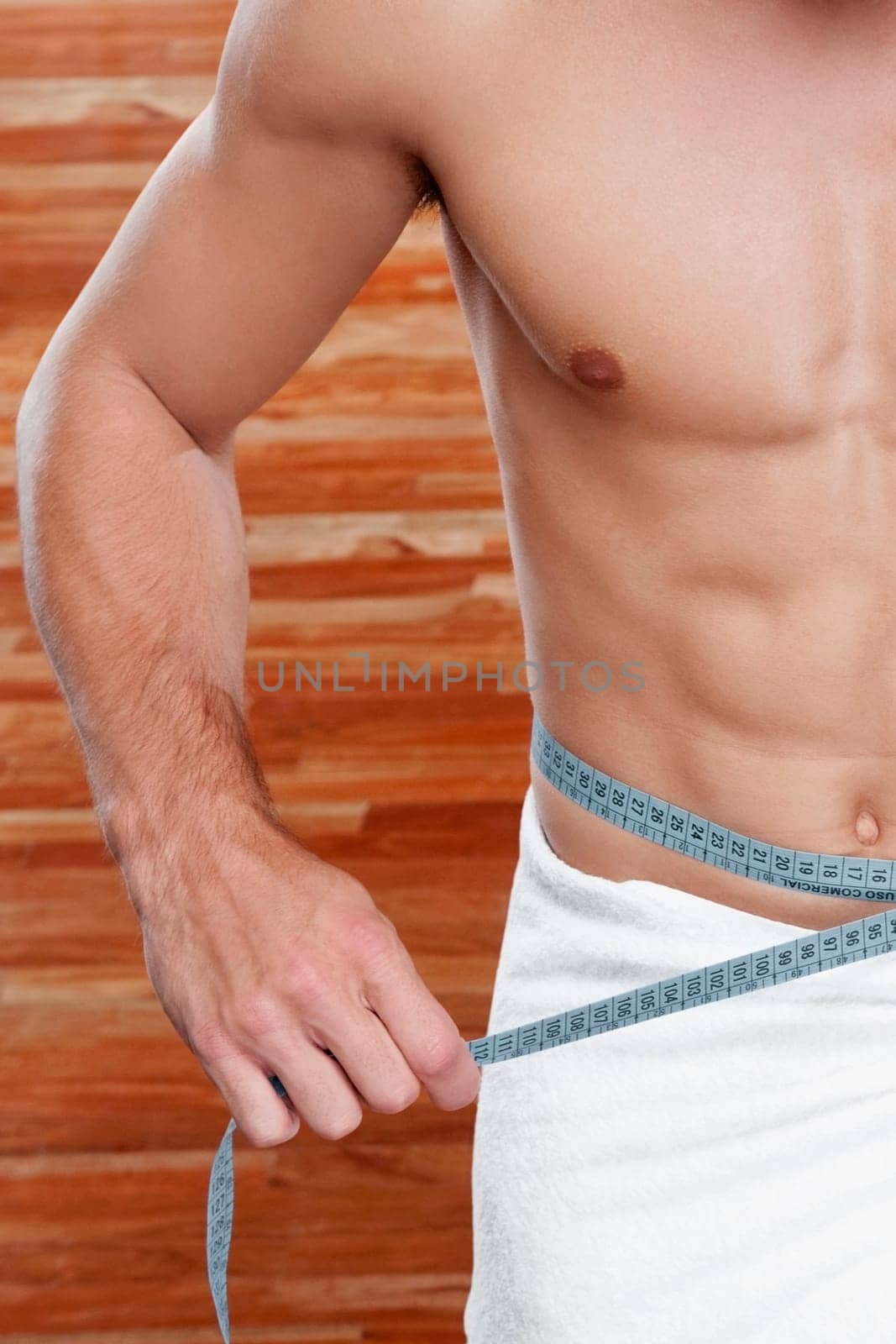 Man measuring his waist with a tape measure