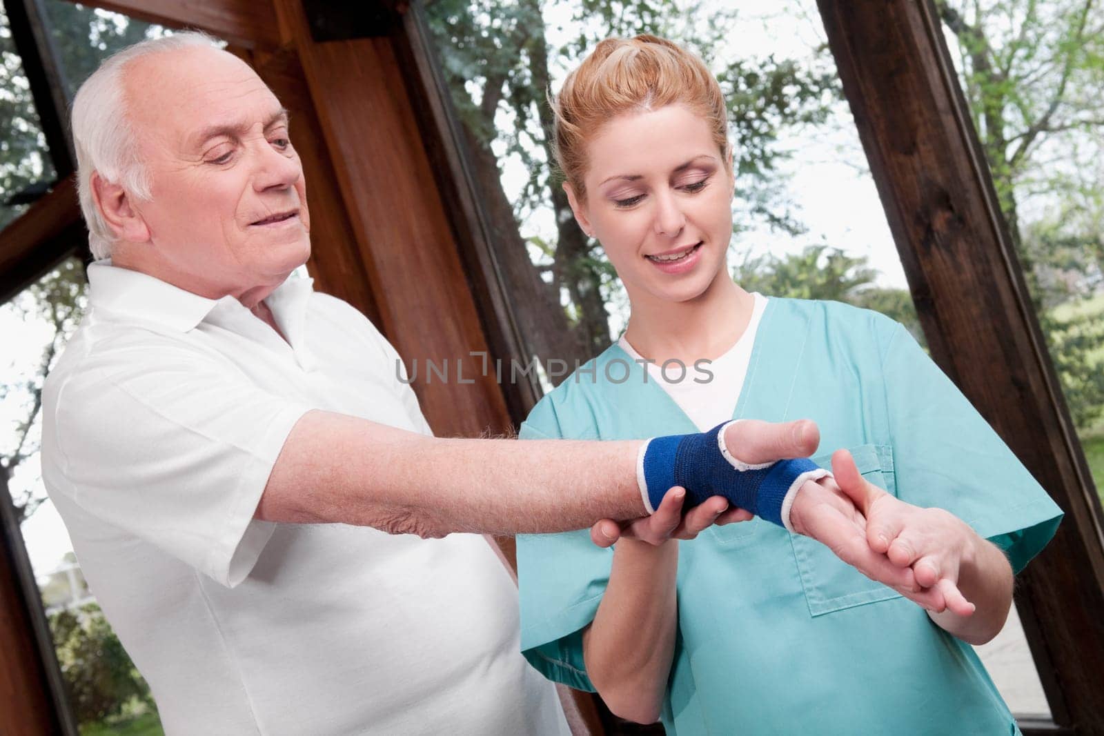 Health worker putting on wrist brace to a man