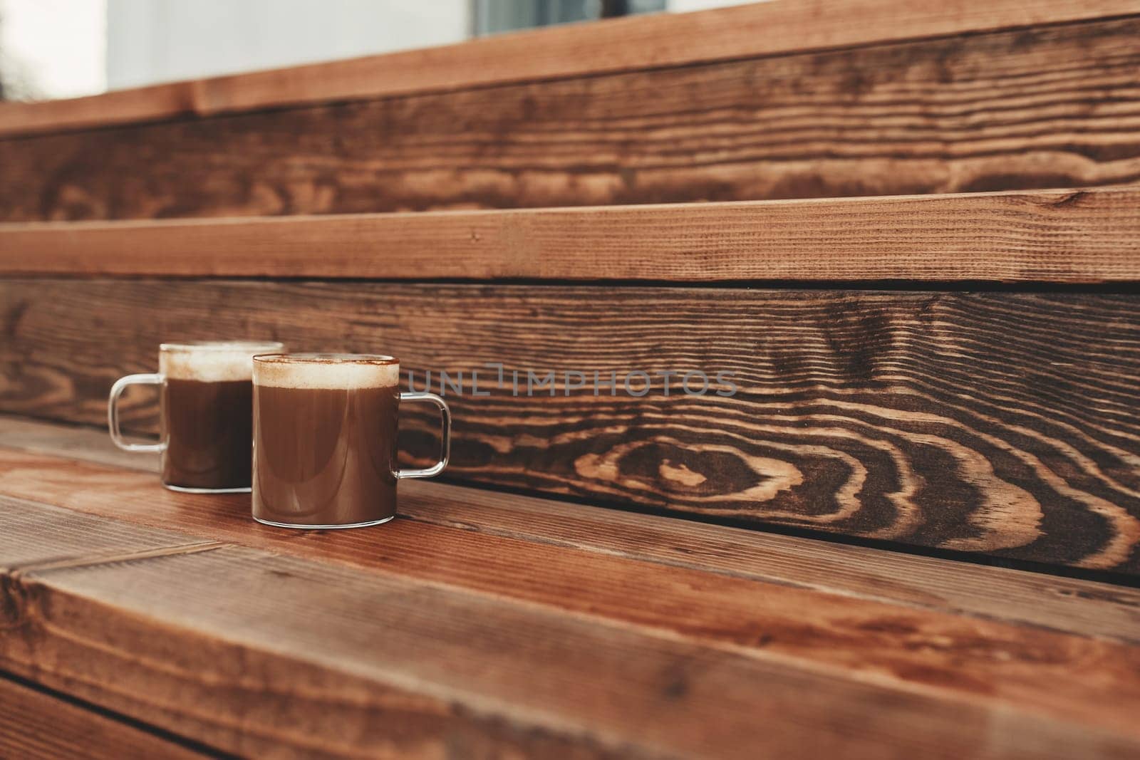 Two cups of coffee in the wooden brown terrace background. High quality photo