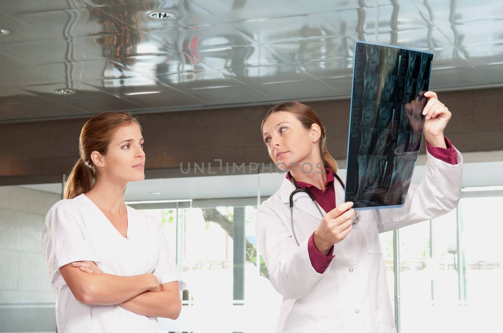 Female doctor showing MRI scan report to a nurse