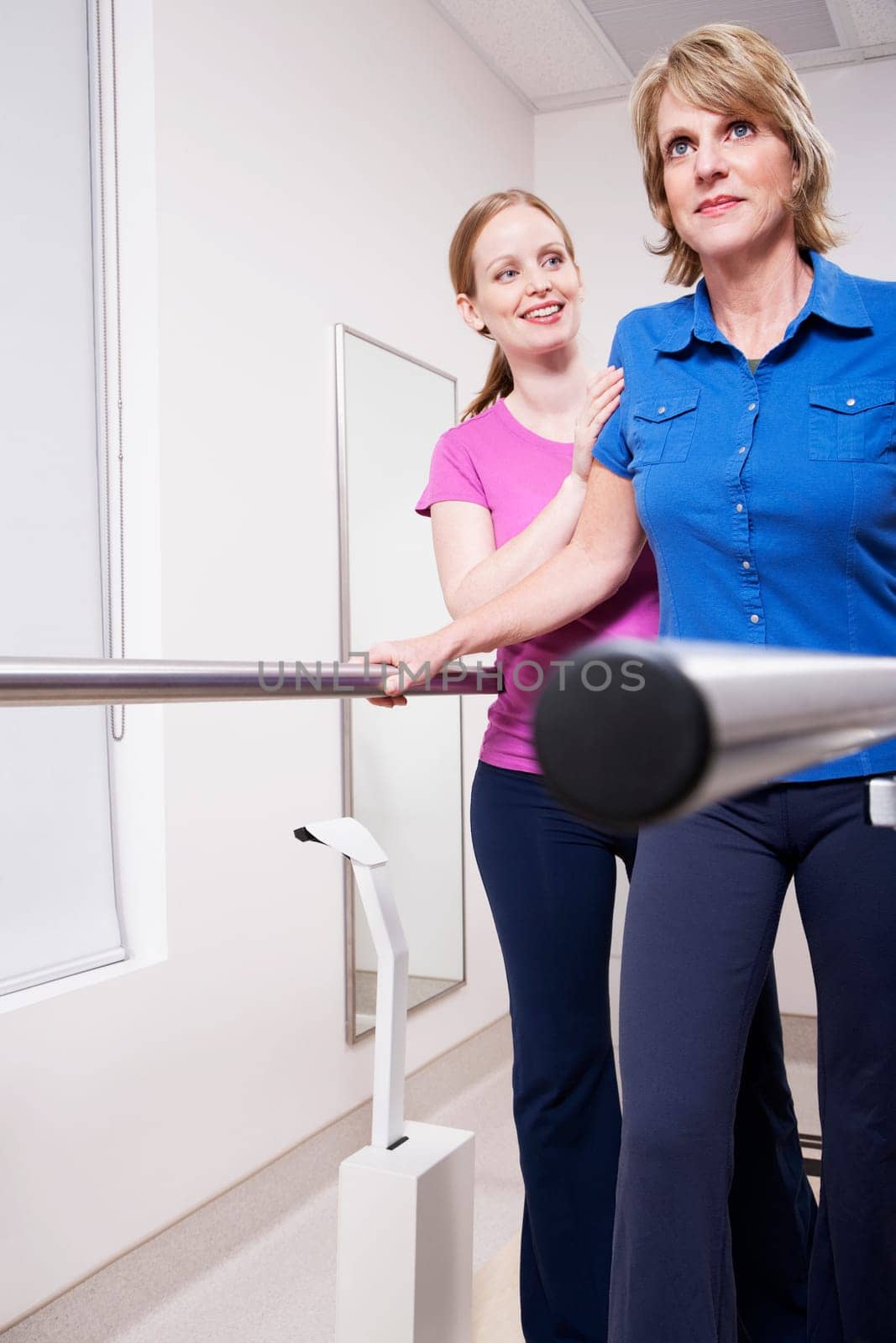Physiotherapist assisting a patient in walking