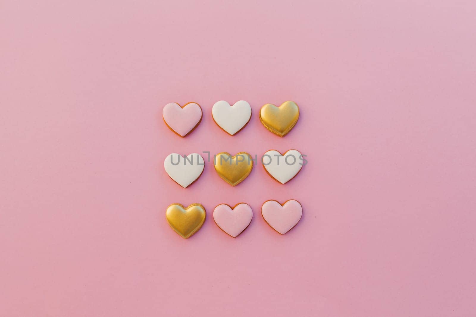 Pink background with sweet gingerbread heart cookies. High quality photo