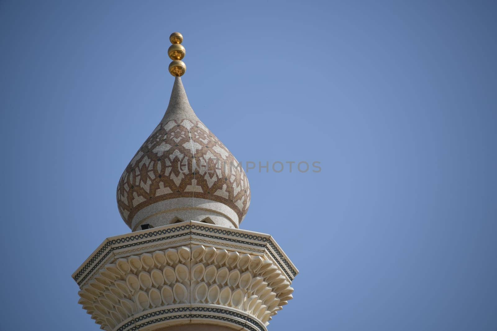 A view of the minaret spire of the mosque in Nizwa. The oasis city is located in the heart of Oman on the Arabian Peninsula.