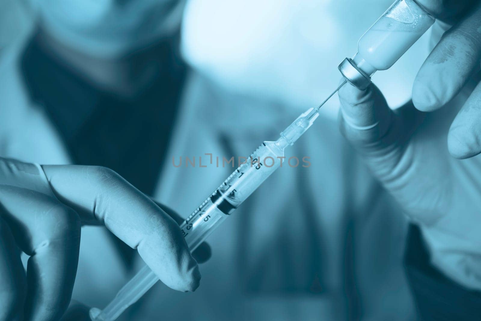Medicine doctor with syringe in hand. Healthcare and medical concept.