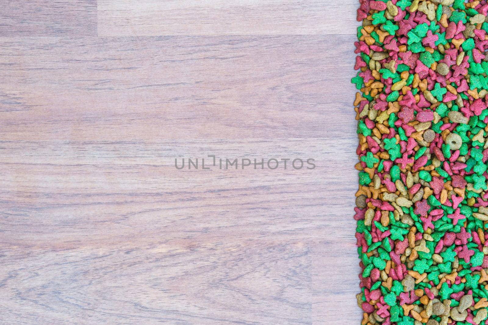 Top view dry cat food on wooden background with copy space