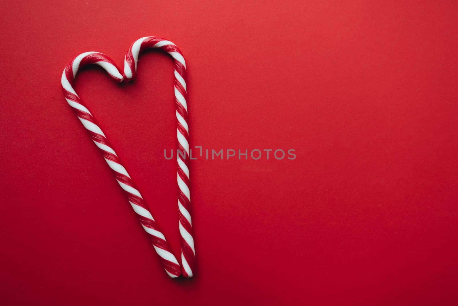 Christmas candies on red background, red white lollipop. High quality photo