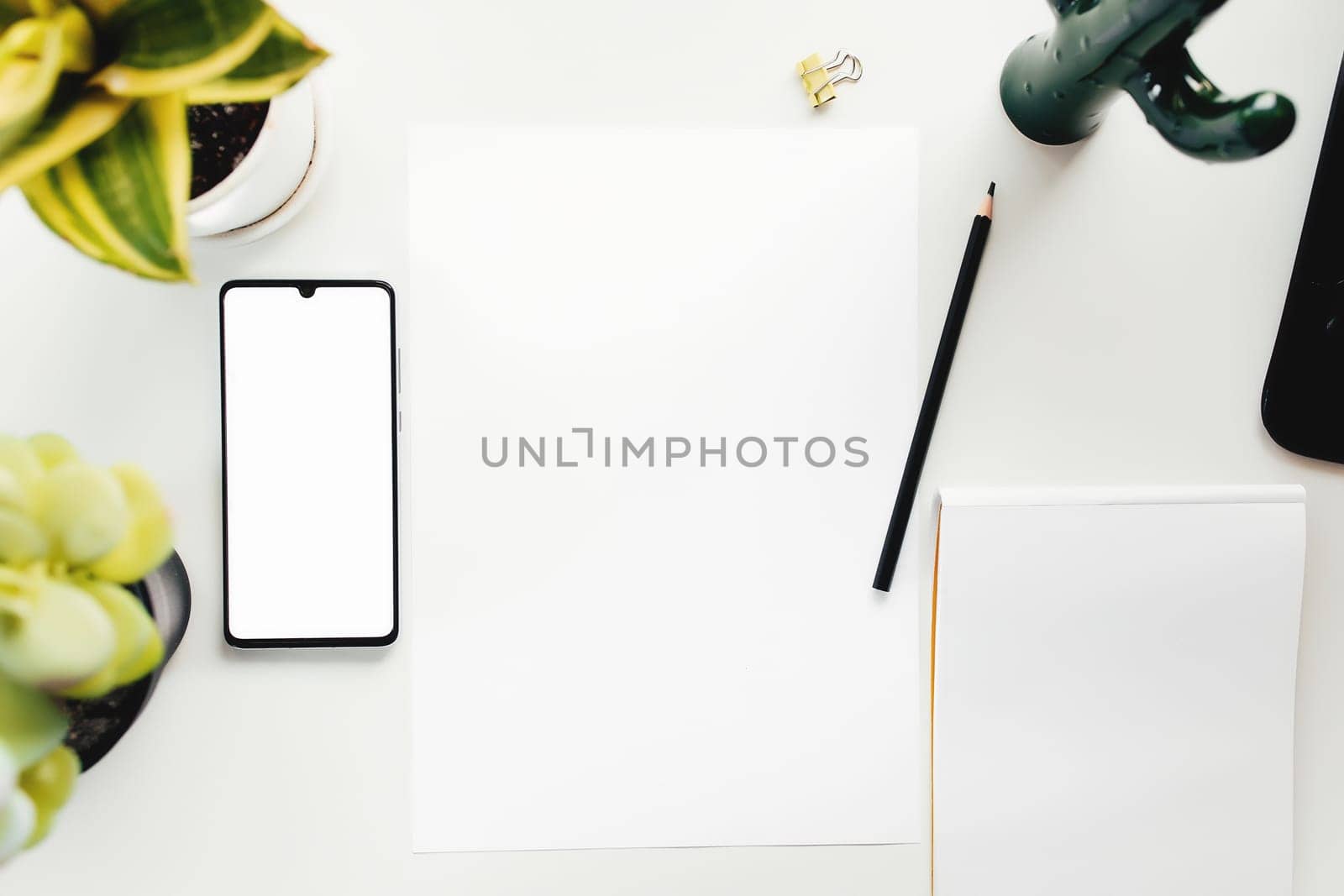 Smartphone on white table, work from home, office stuff. High quality photo