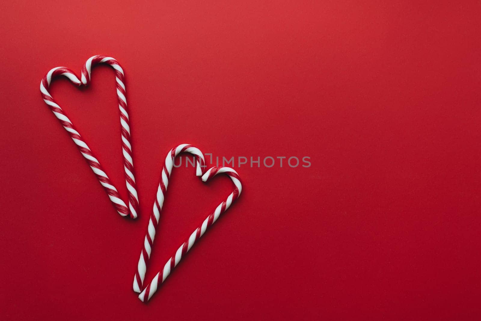 Christmas candies on red background, red white lollipop. High quality photo