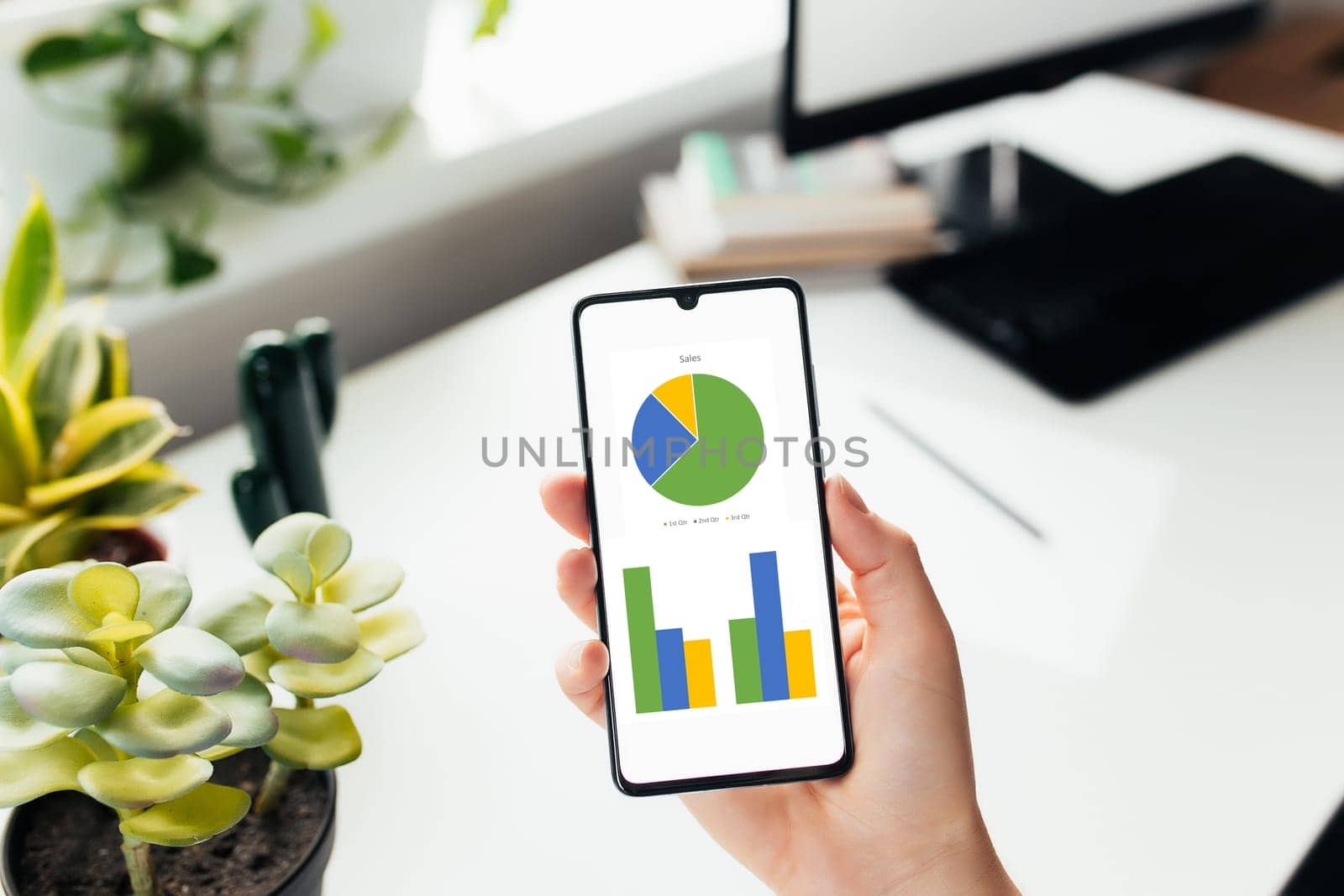 Smartphone in the hand, work from home, office stuff. High quality photo