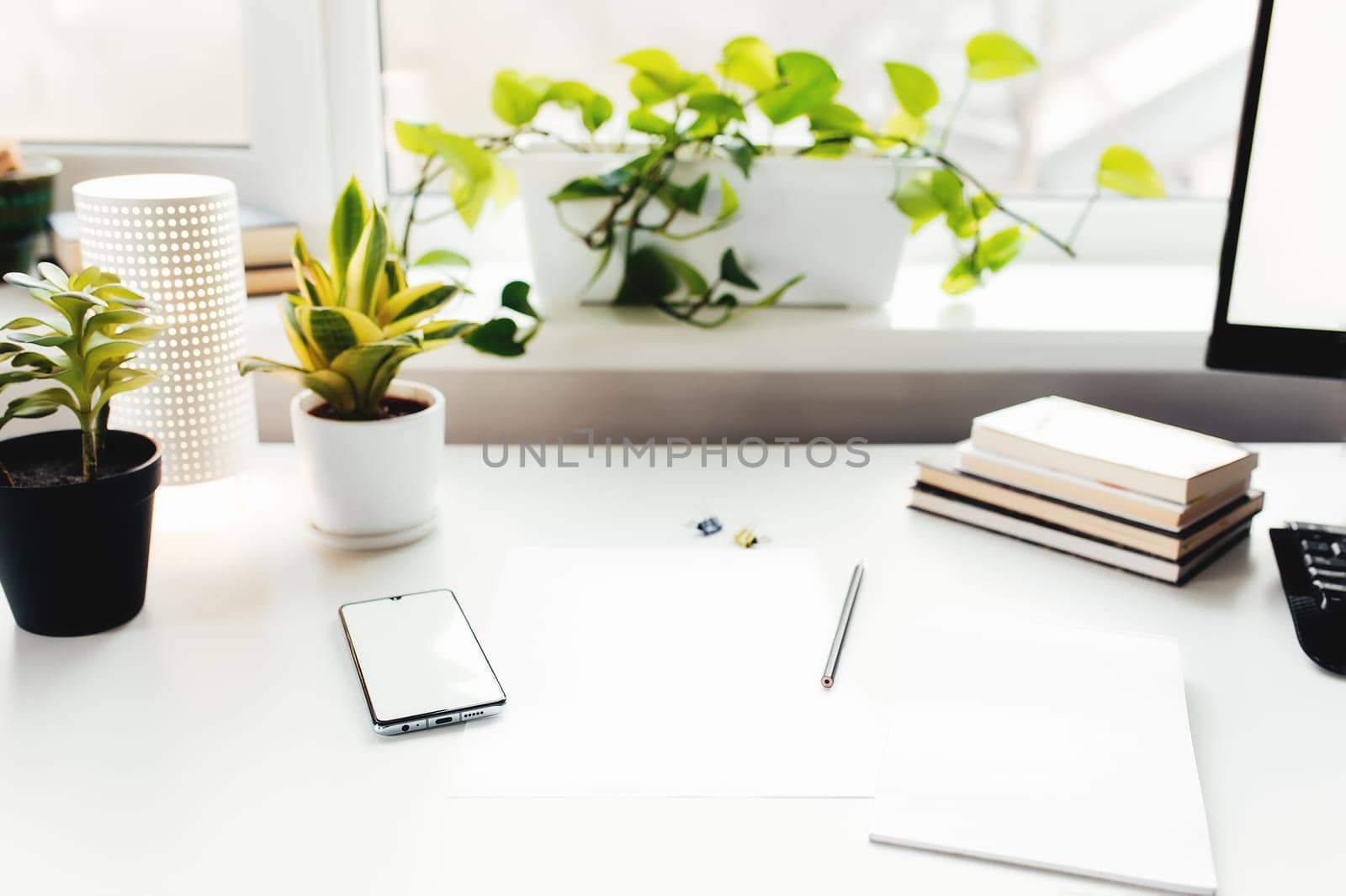 Smartphone on white table, work from home, office stuff. High quality photo