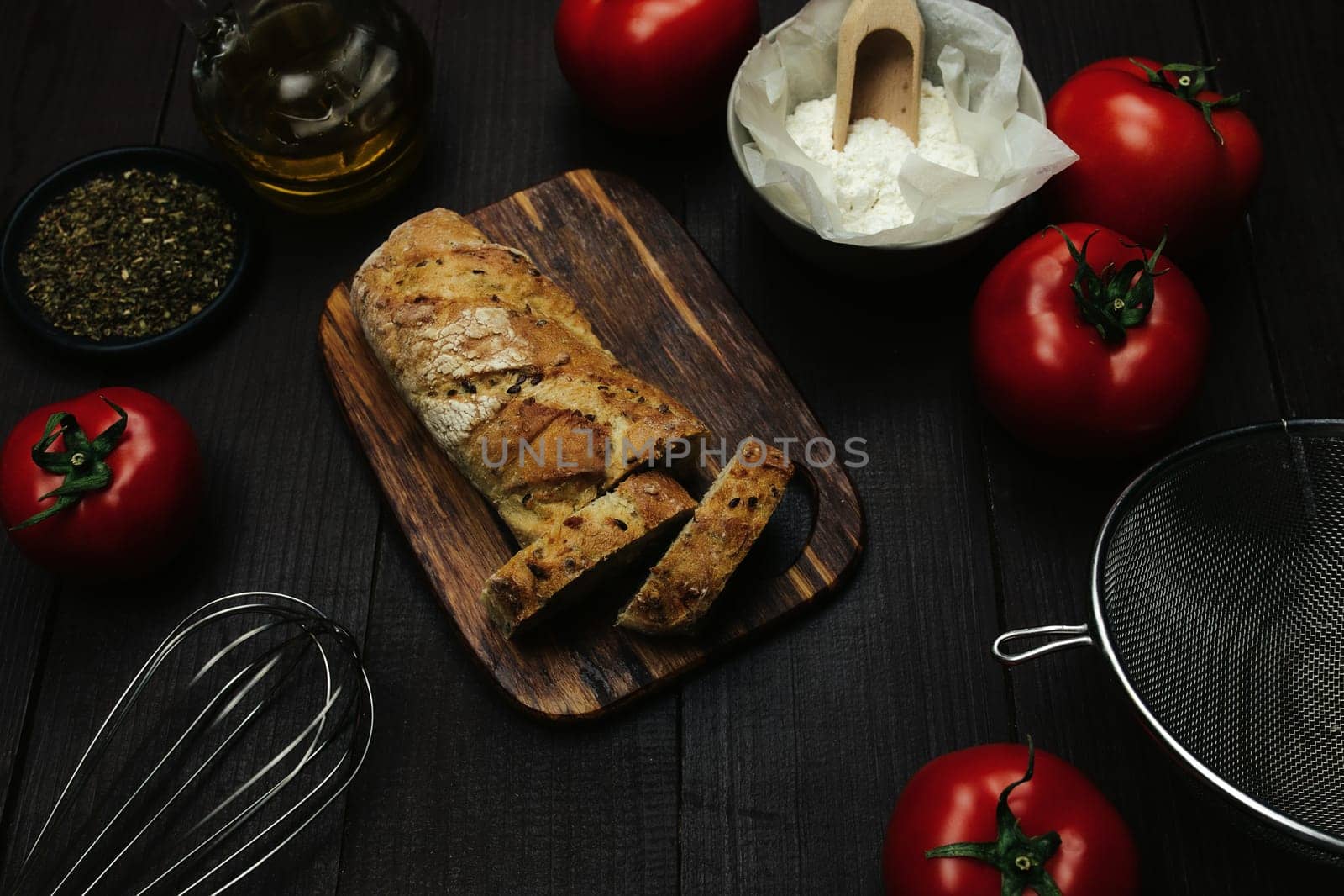 Fresh baked bread and baking ingredients on a table . High quality photo