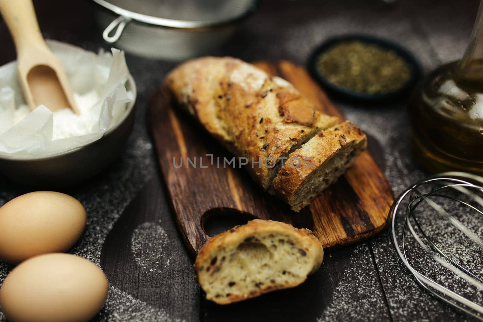 Fresh baked bread and baking ingredients on a table. High quality photo