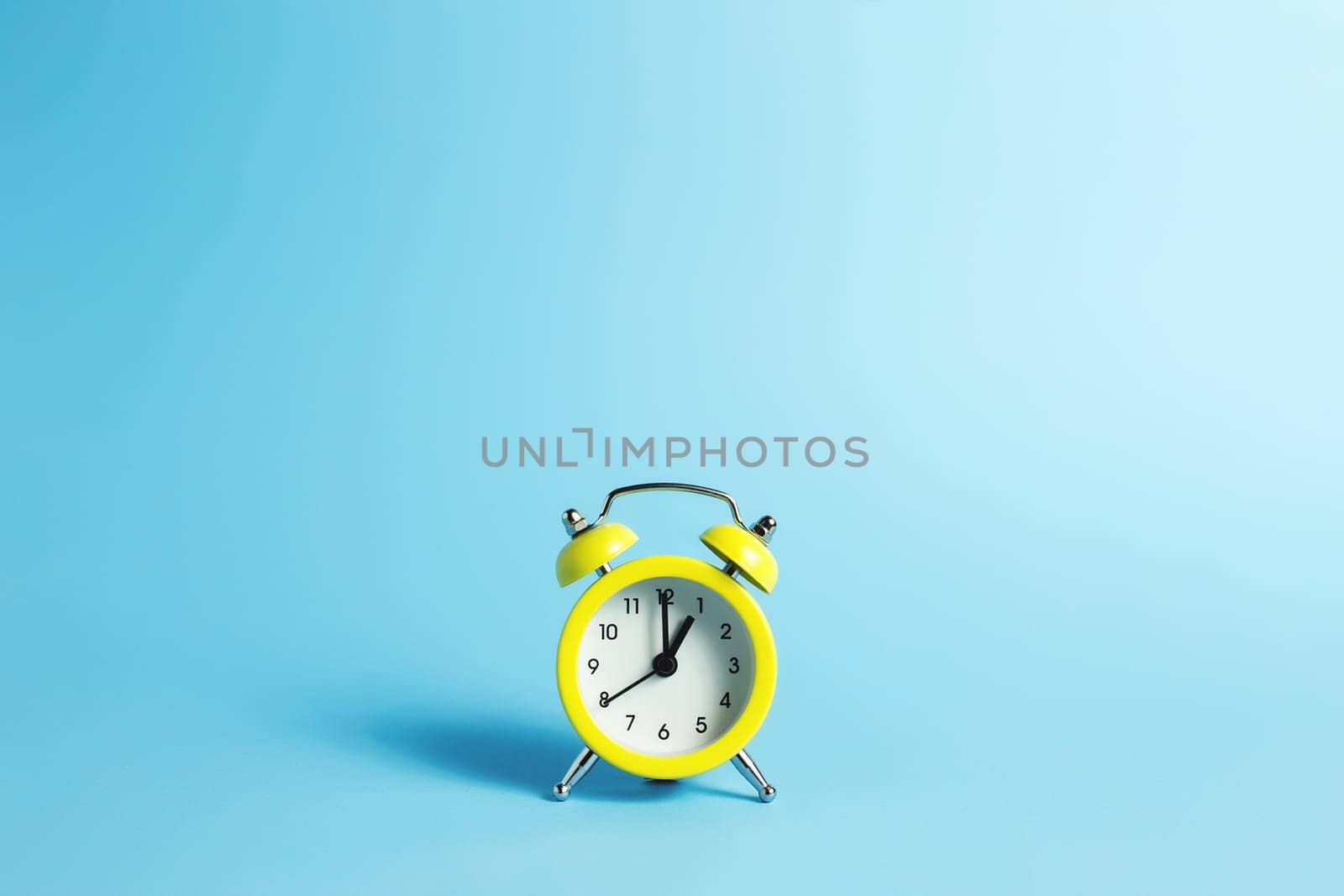 Mechanical alarm clock on the blue background. High quality photo