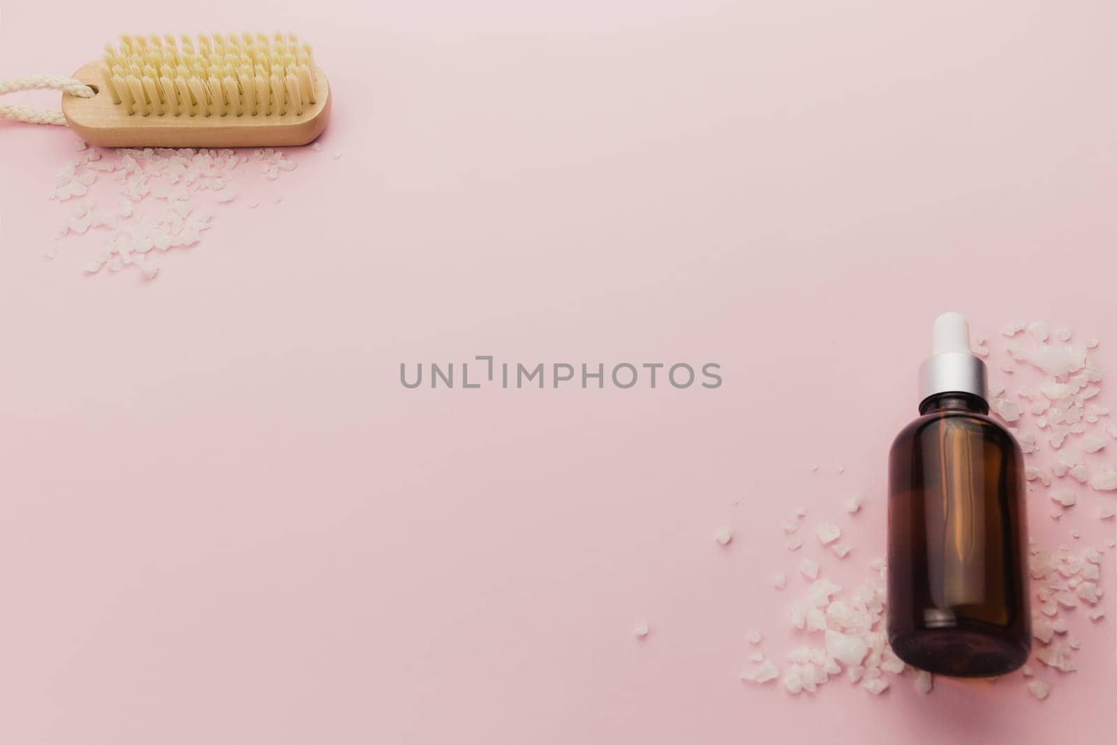Bottle of cosmetic oil and brush on pink background. High quality photo