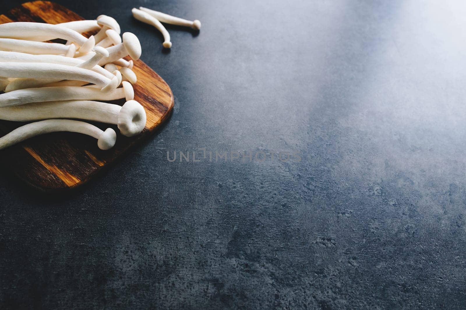 Cooking white mushrooms on the dark gray background. High quality photo