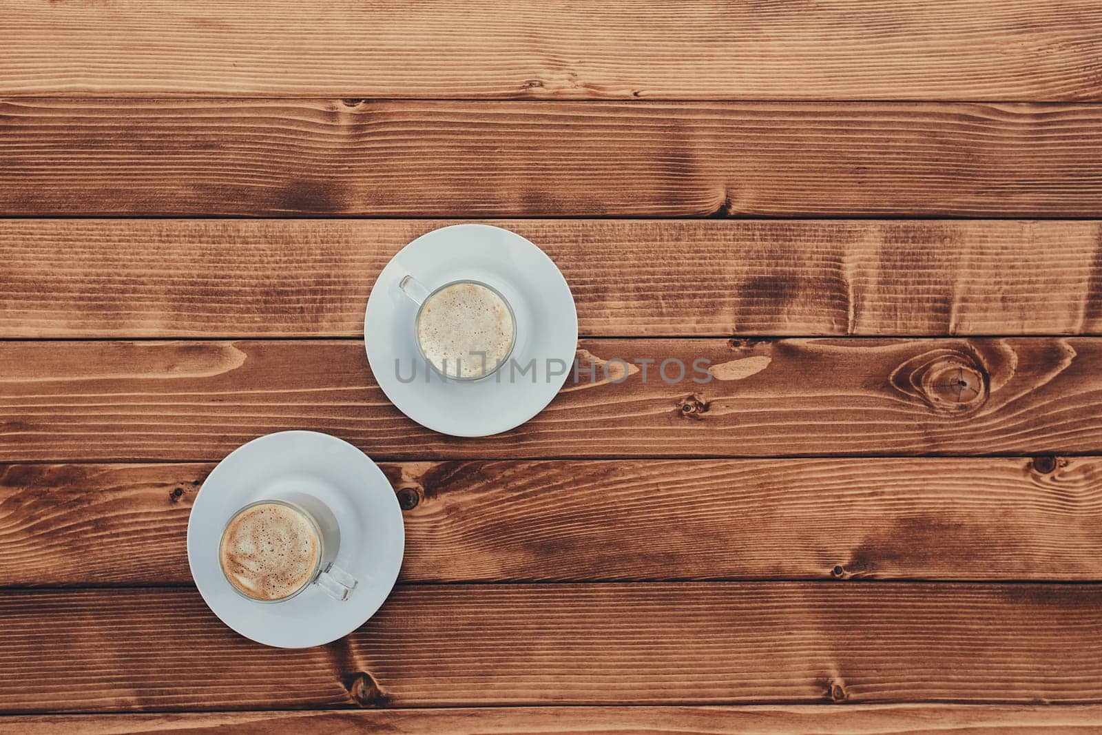 Two cups of coffee in the wooden brown terrace background. High quality photo