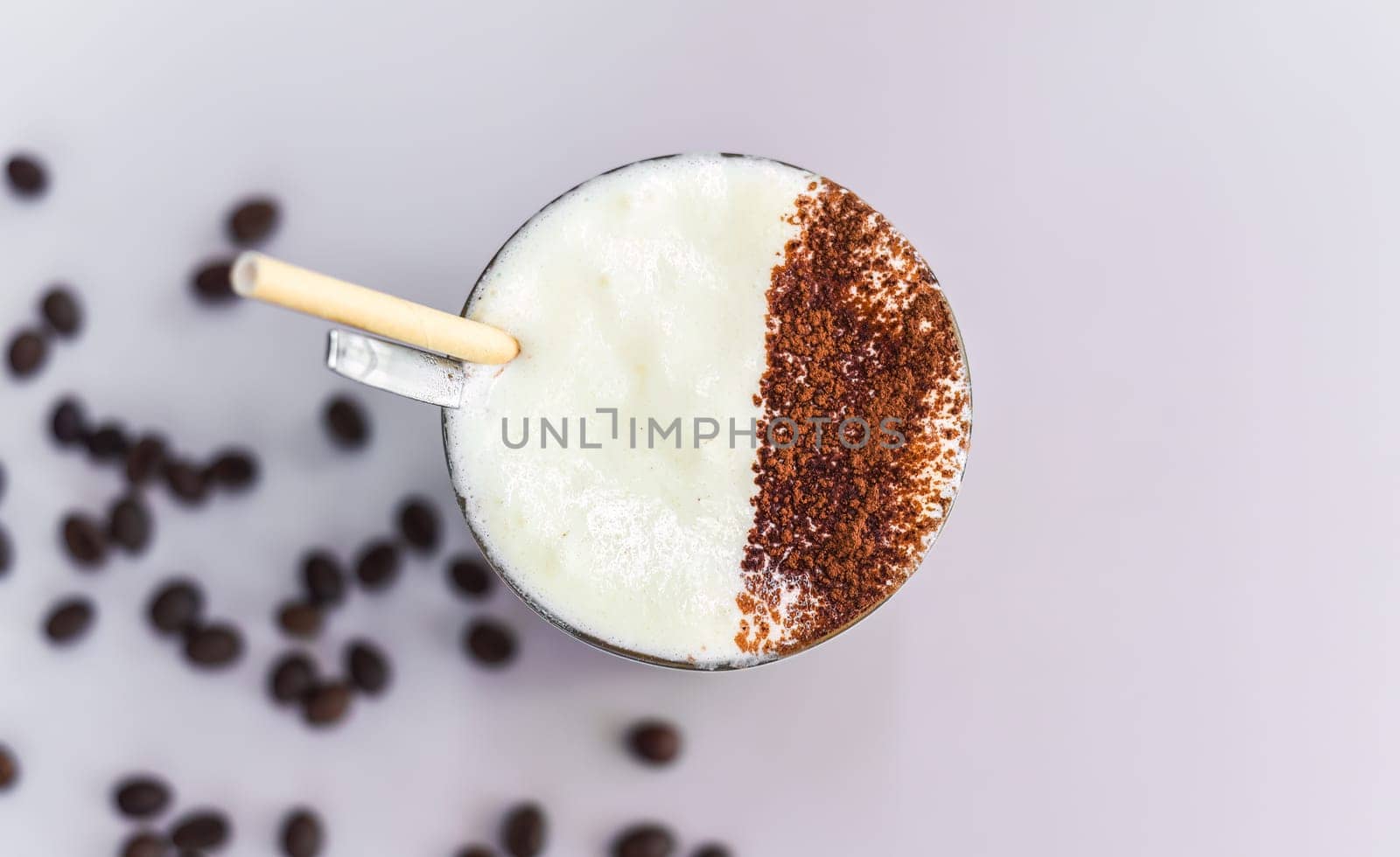 Vietnamese salted coffee with salty cheese cream (ca phe muoi) against green leaves