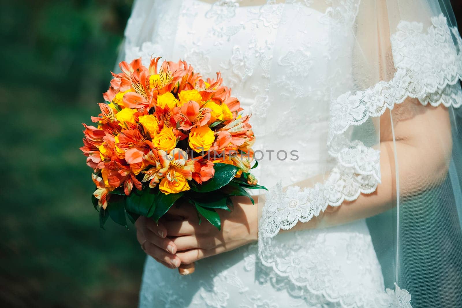 Bride with a bouquet of orange flowers. Wedding bouquet.