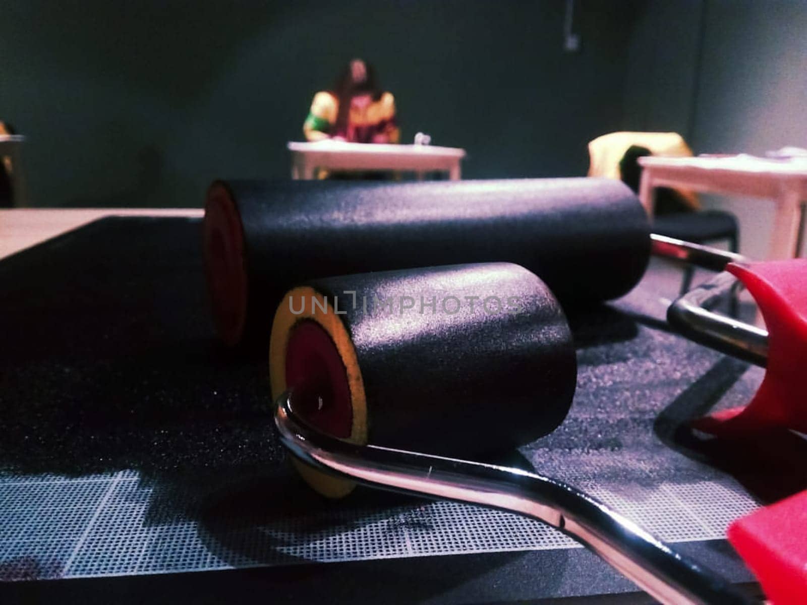 Rollers for painting in black paint. Painter's tools.