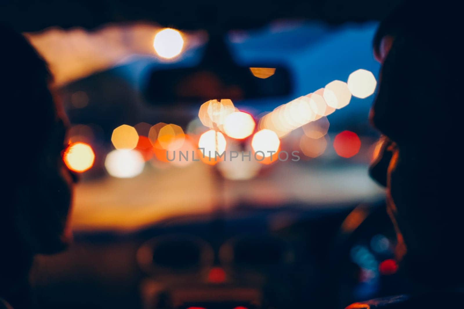 Blue photography. A man and a woman are sitting in a car.