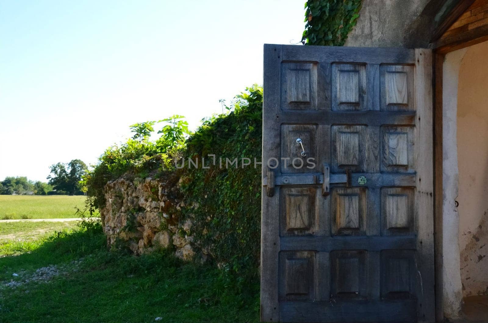 An old wooden door, a stone fence.