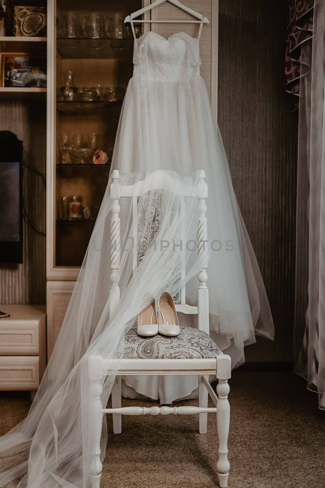 Wedding dress, white shoes on the chair. The bride's clothes.