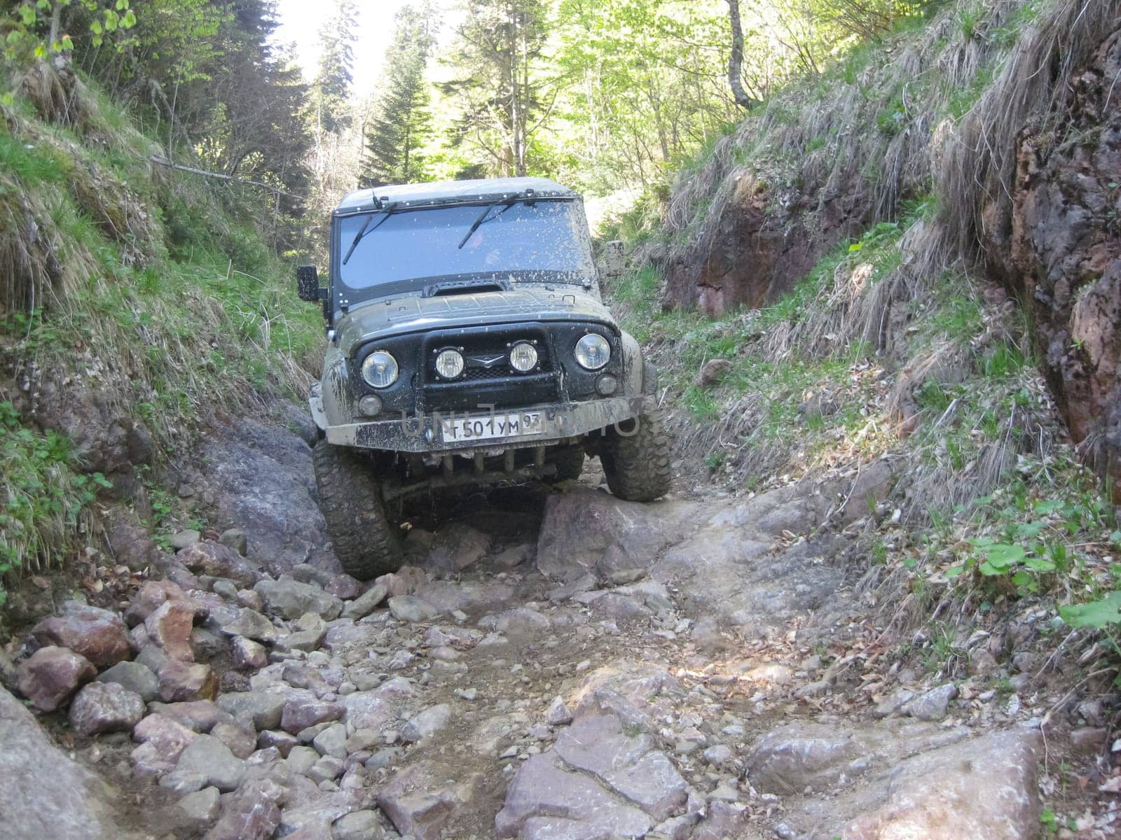 Moscow, Russia - June 23, 2019: It's a very dirty car. The SUV is driving through the mud.