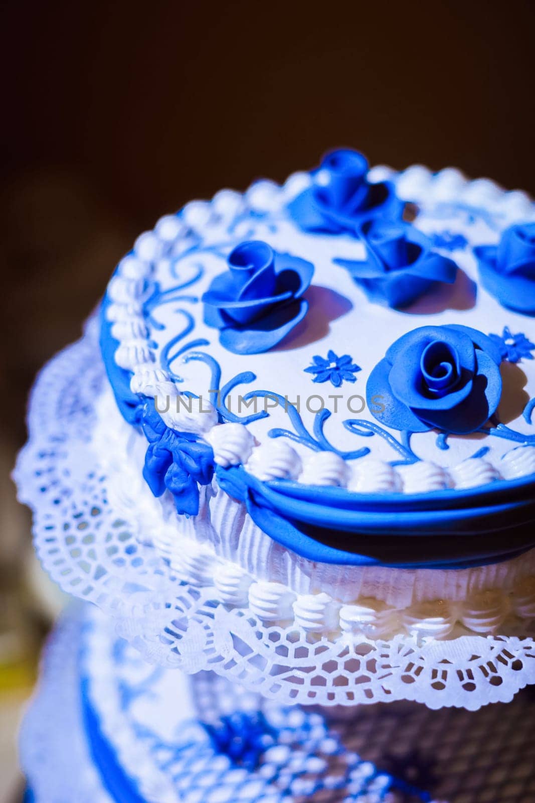 The cream cake is white with blue flowers and patterns.