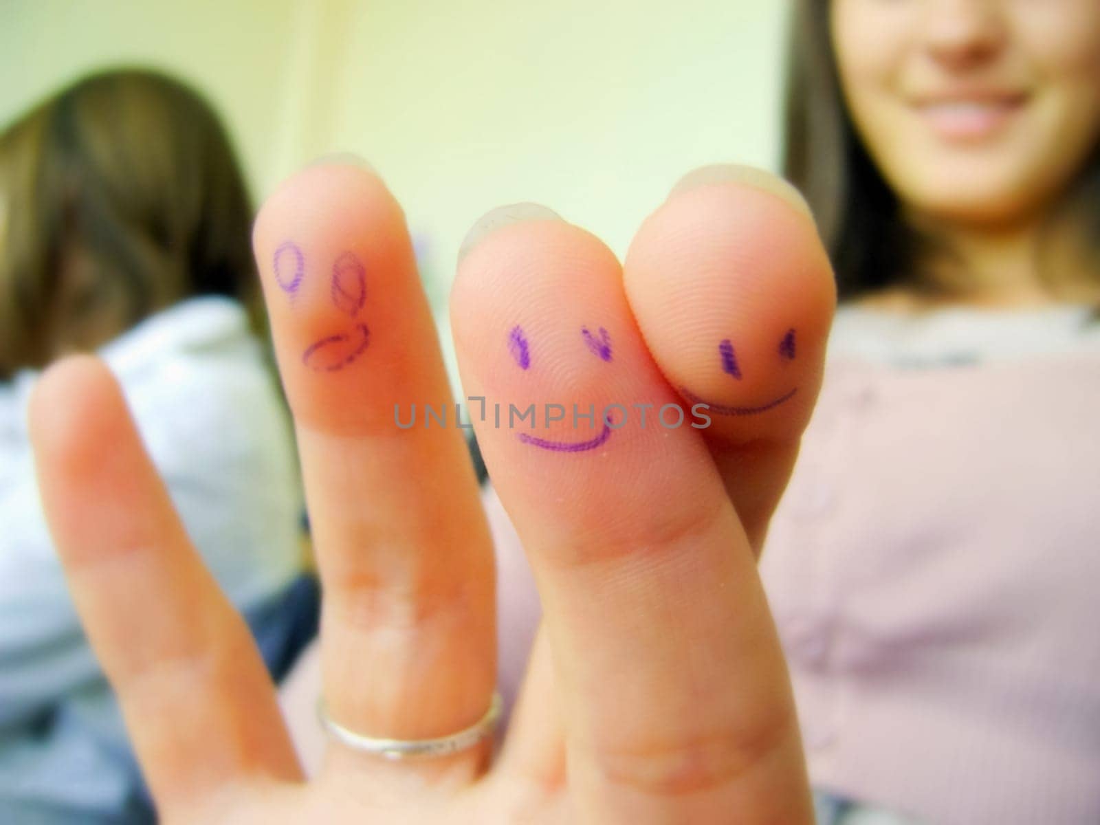 Smiles painted on the fingers with a ballpoint pen.