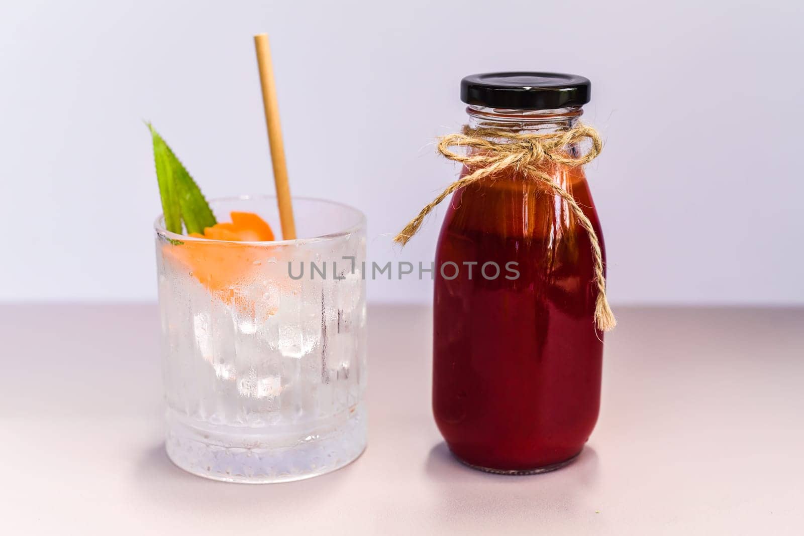 Healthy mixed juice made of carrot, orange fruit, pink dragon fruit, apple with glass with ice