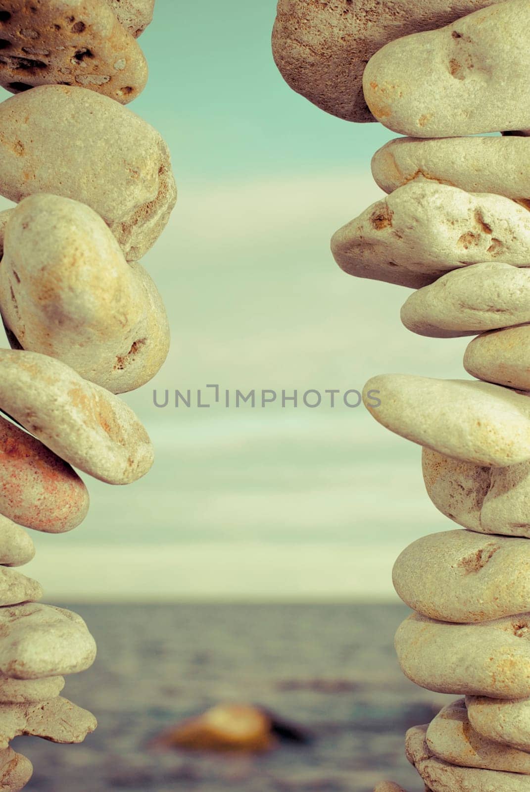 Sea viewed through stacks of pebbles