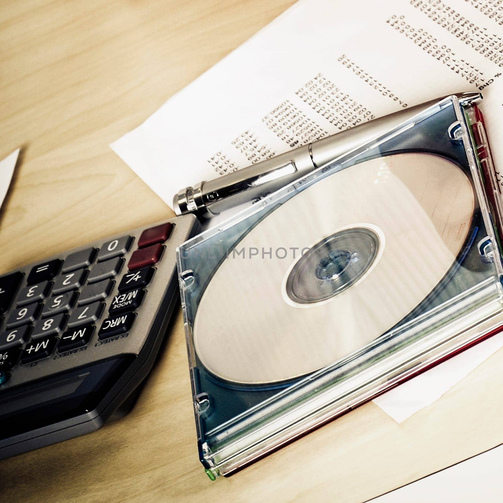 Close_up of a compact disk with a calculator