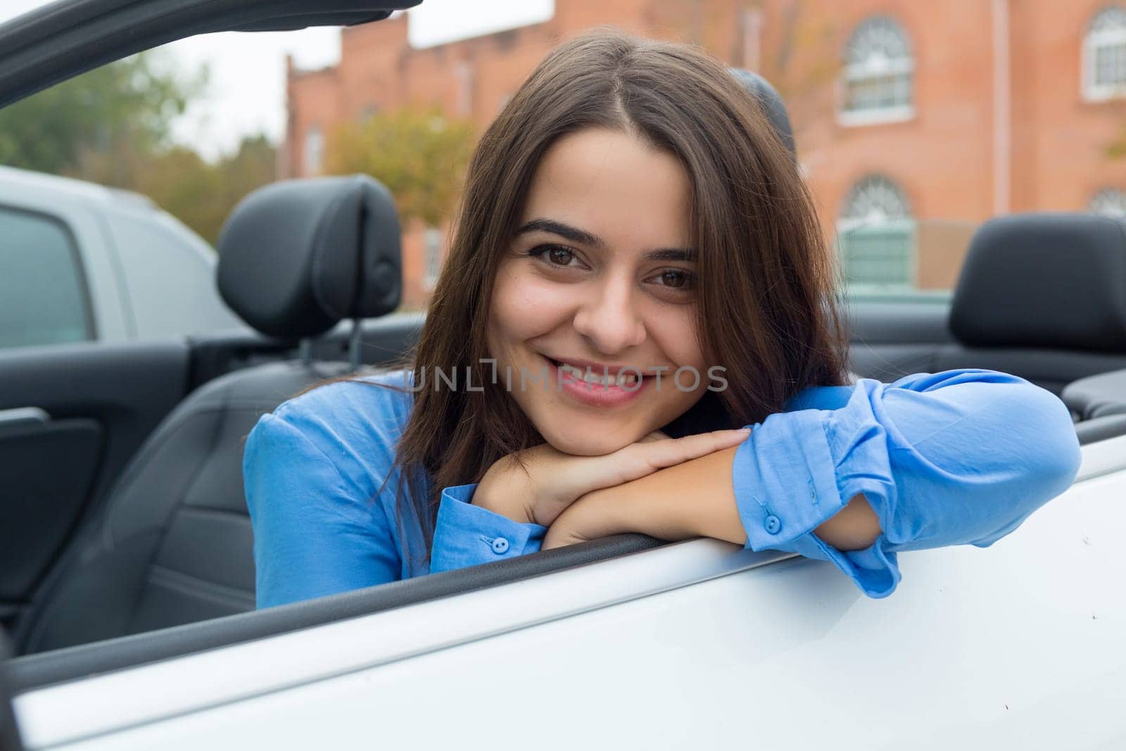 Business woman driving her new sports car