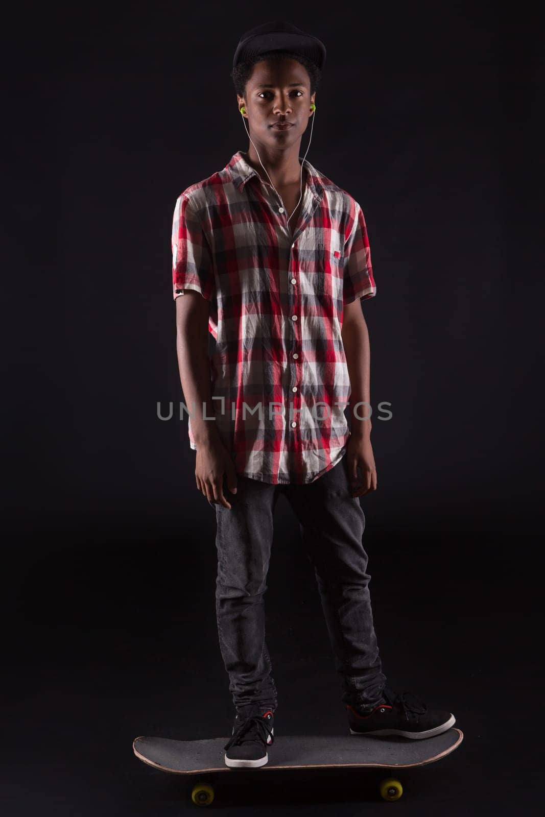 A young black skater posing in studio