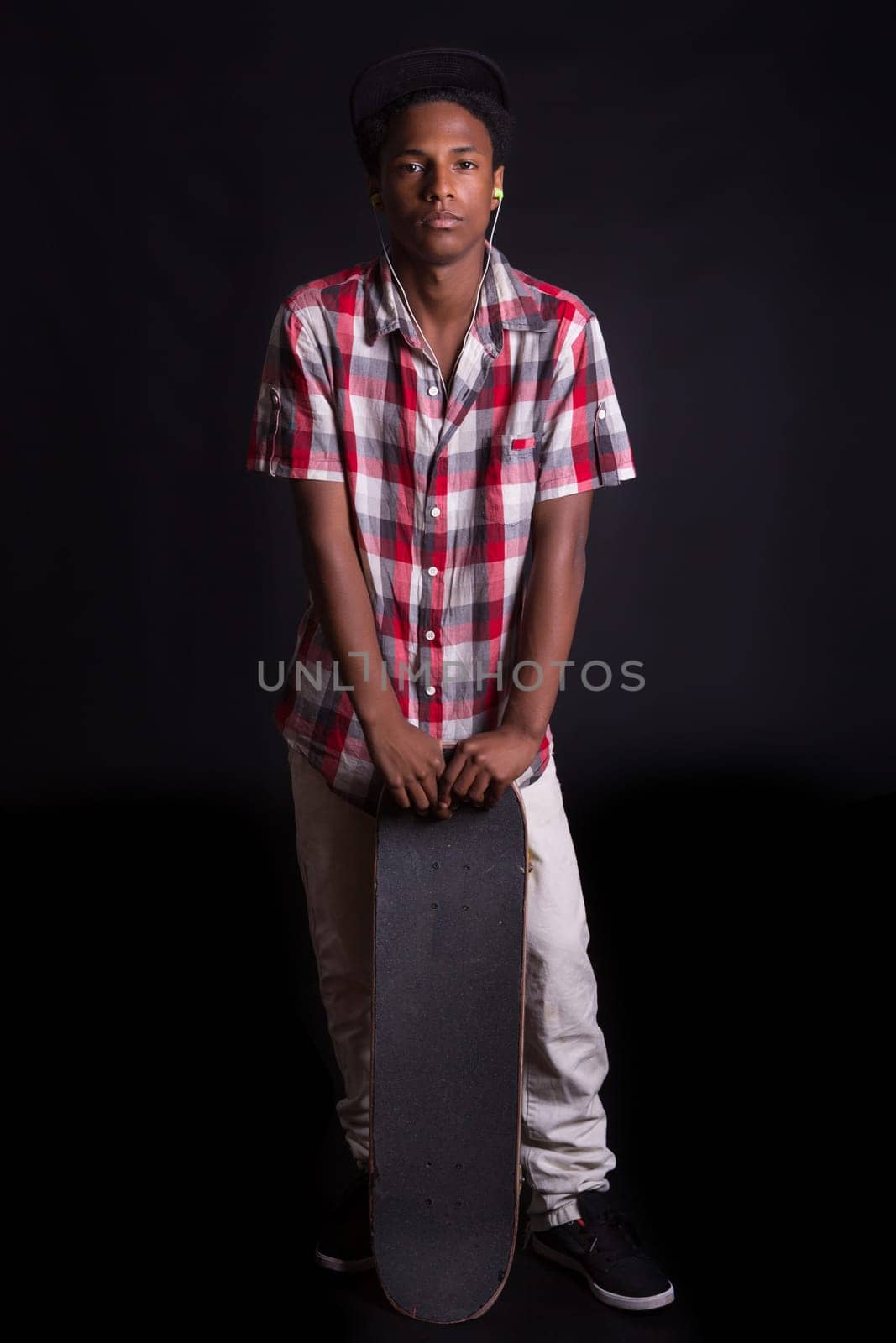 A young black skater posing in studio