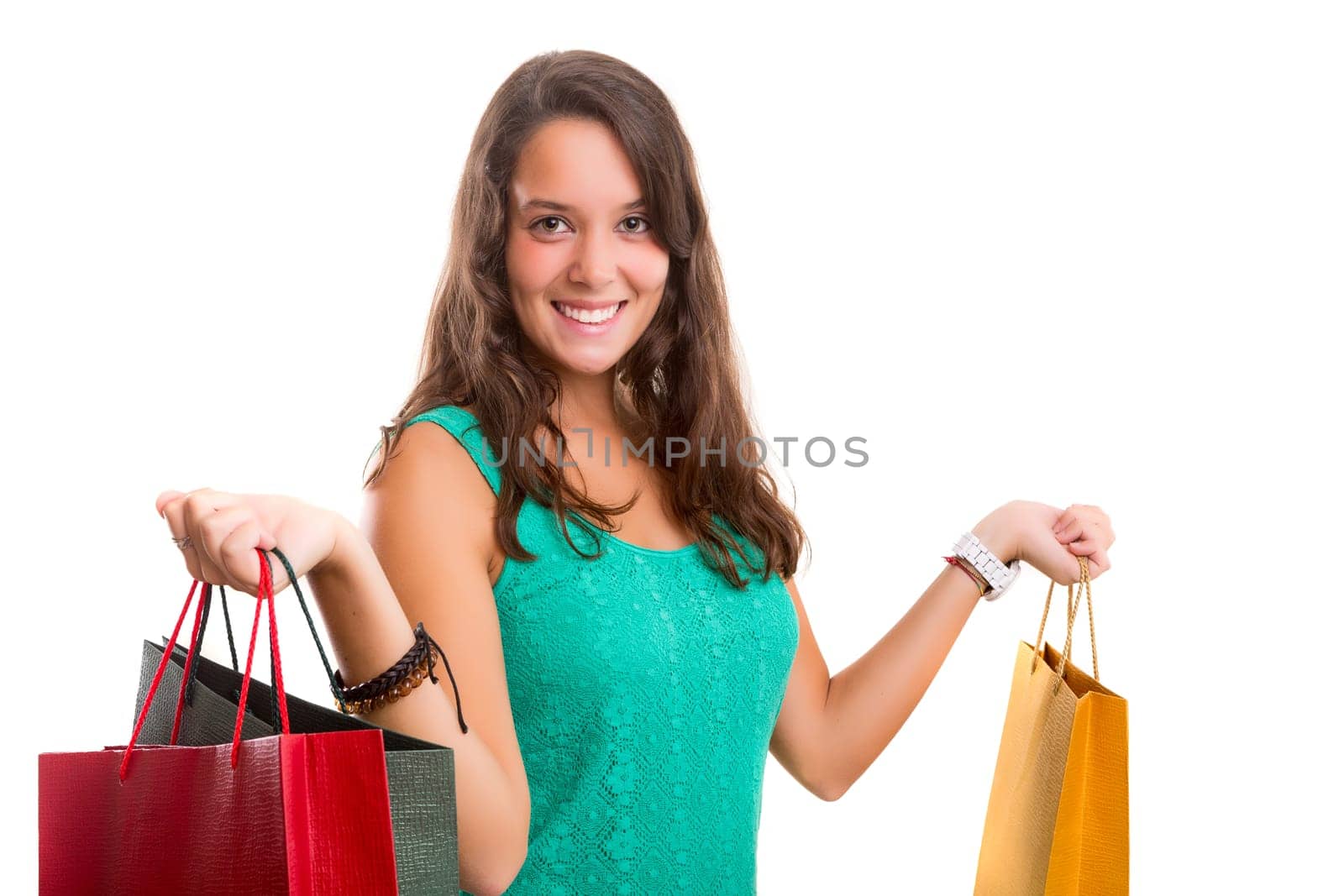 Young beautiful woman with shopping bags, isolated over copy space background