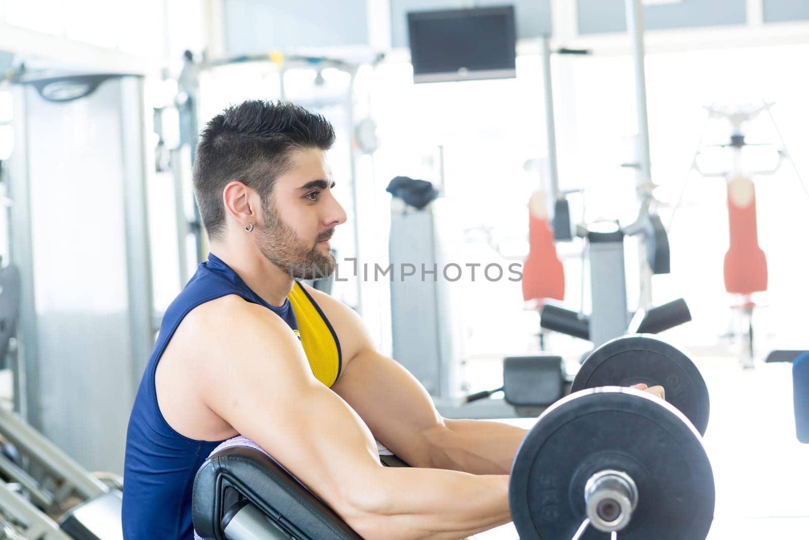 Handsome young man working out at the gym