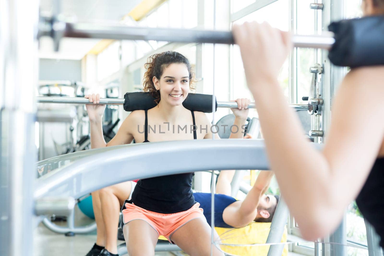 A young and beautiful woman working out at the gym