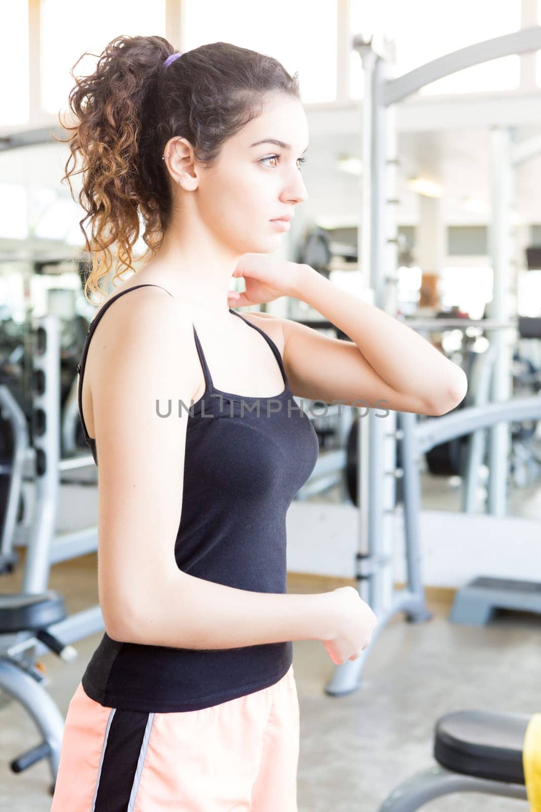 A young and beautiful woman working out at the gym