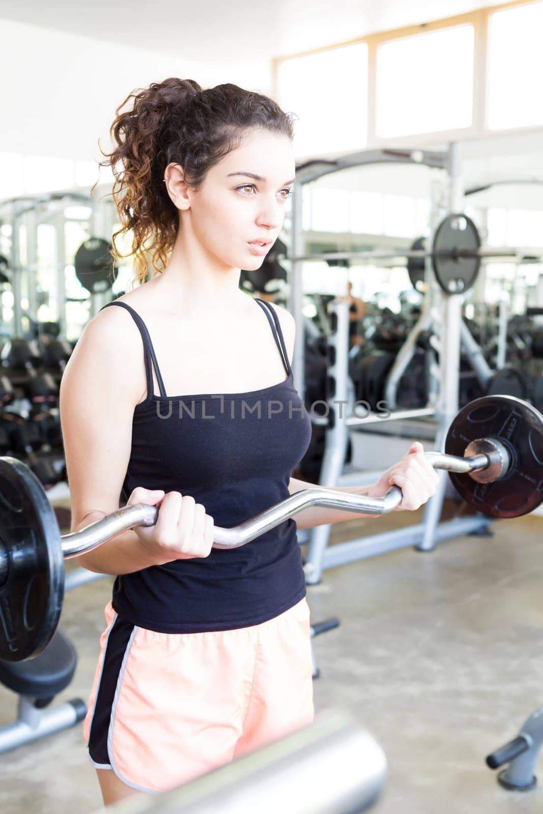 A young and beautiful woman working out at the gym
