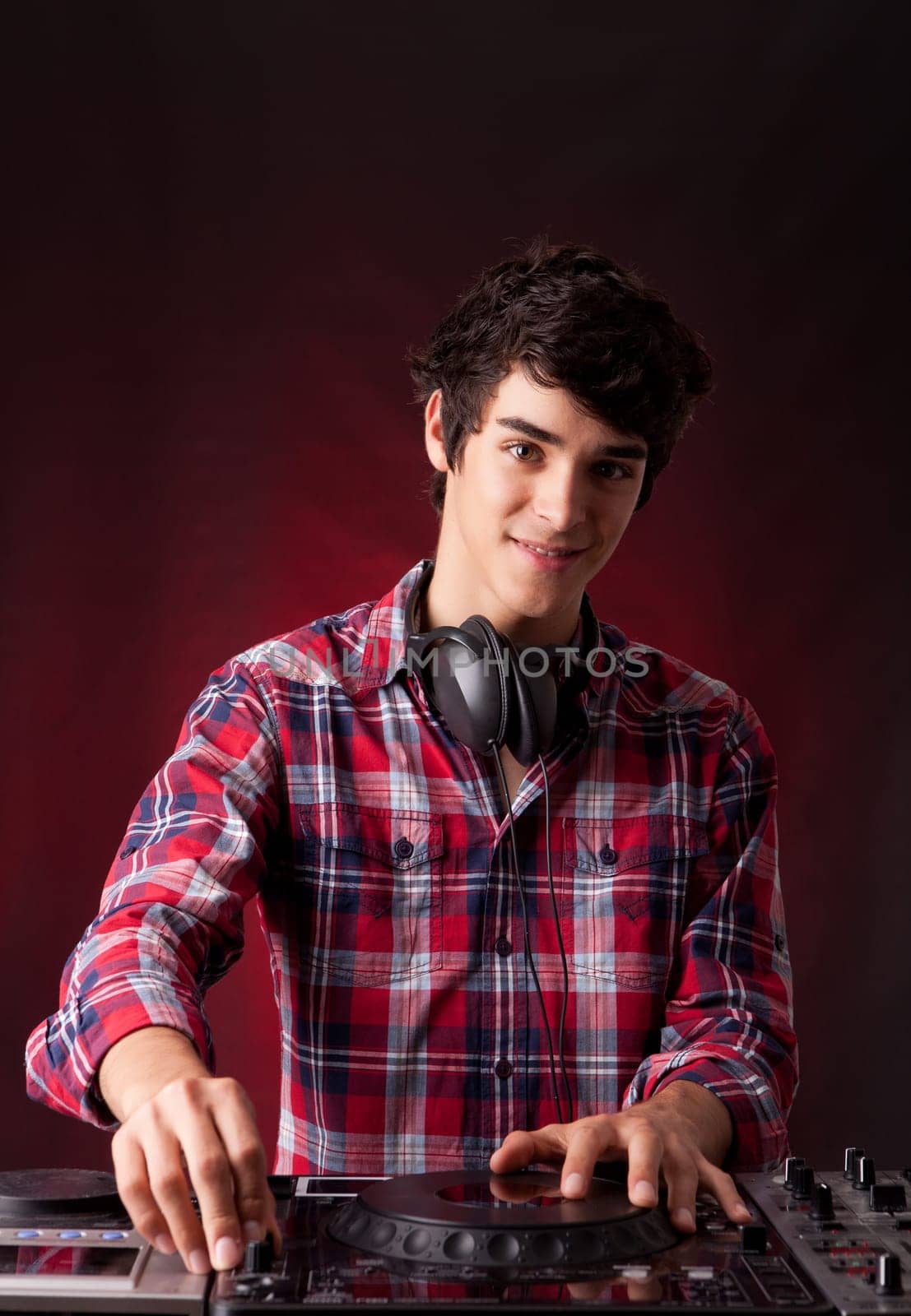 Young and handsome dj playing some music