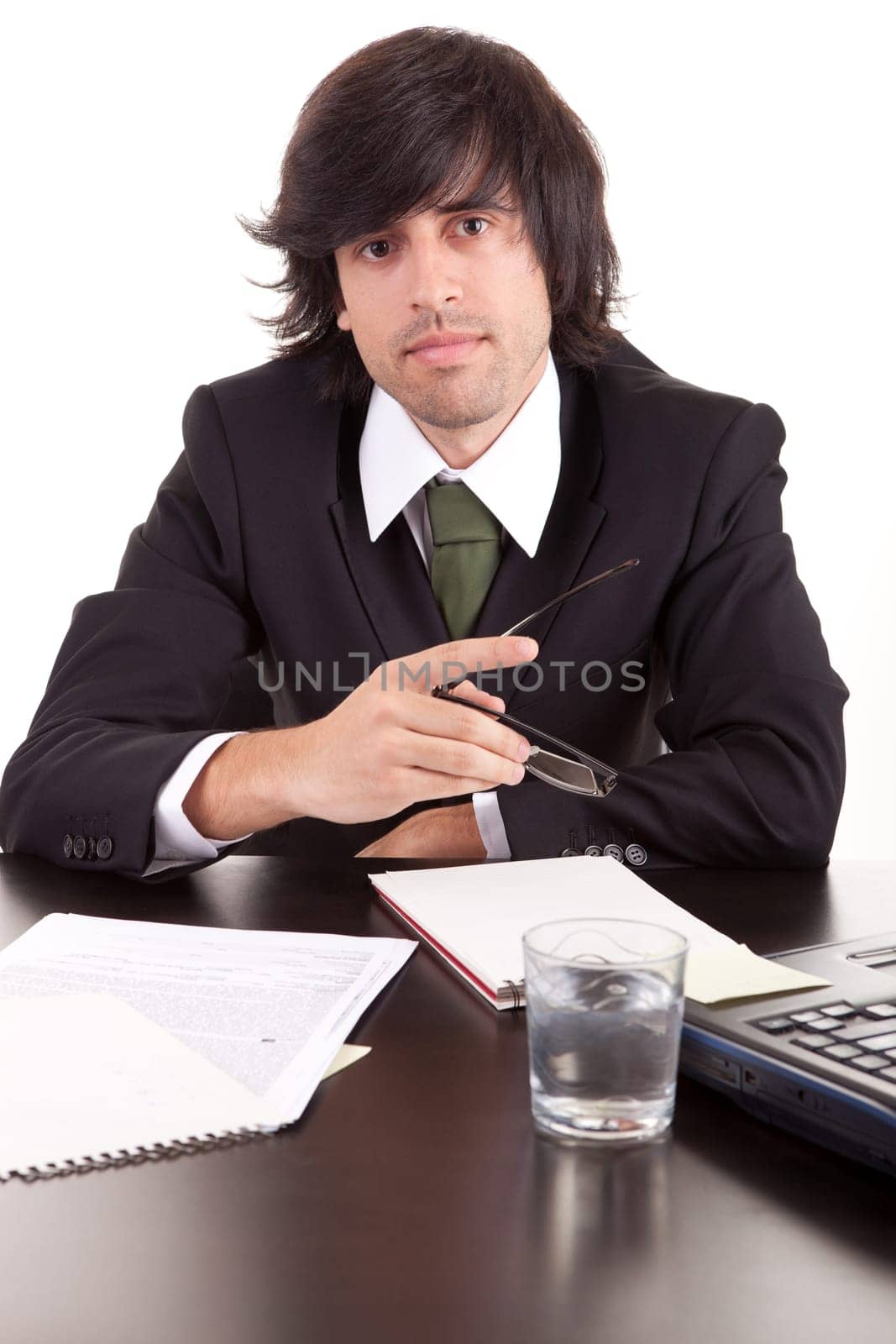 Young business man at work, isolated over white