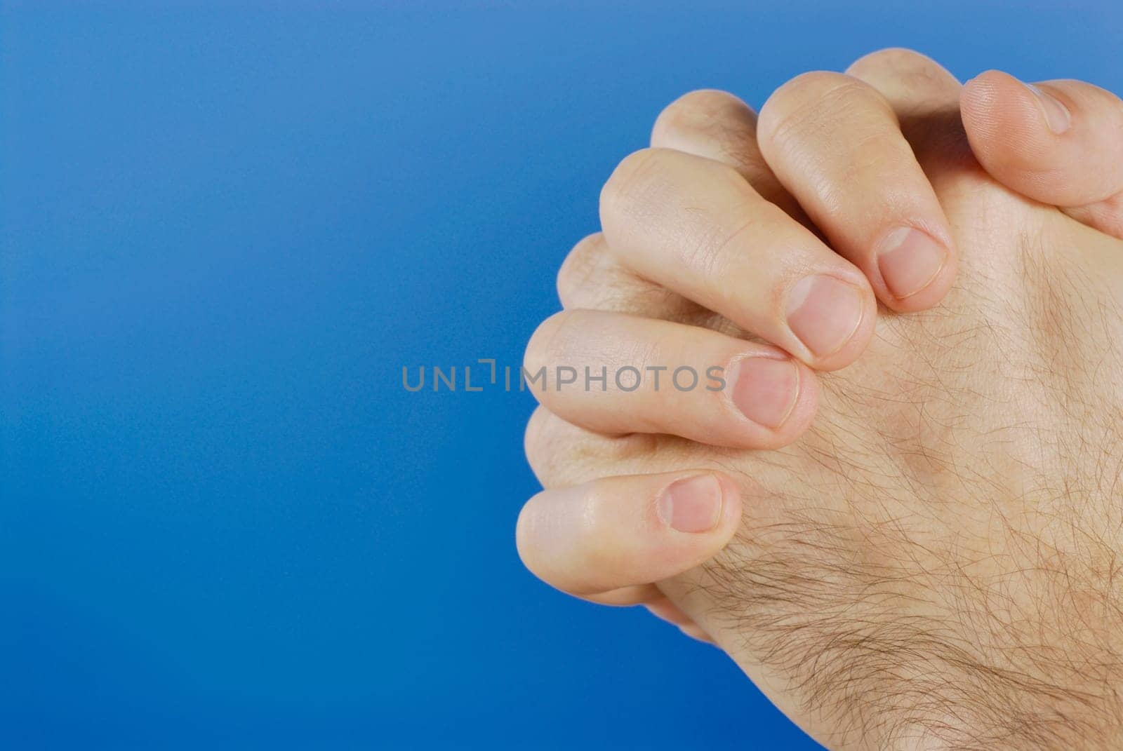 Two hands clenched together