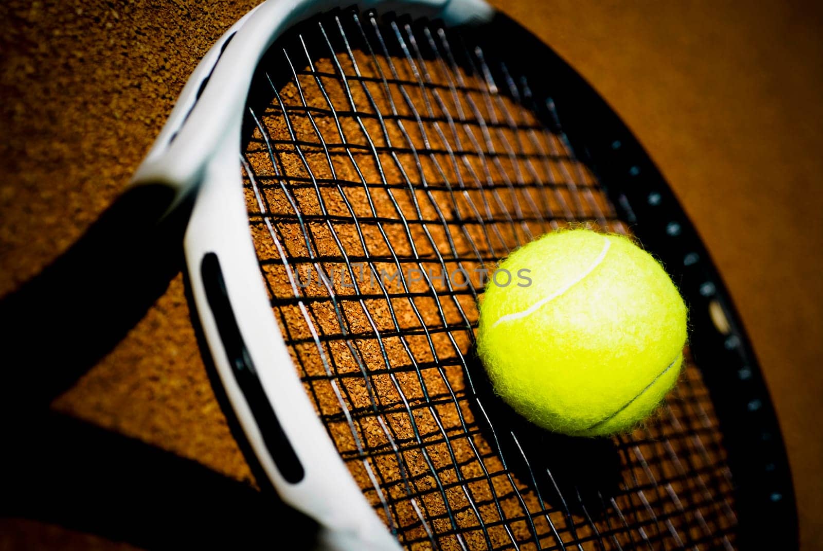 Close_up of a tennis ball on a tennis racket