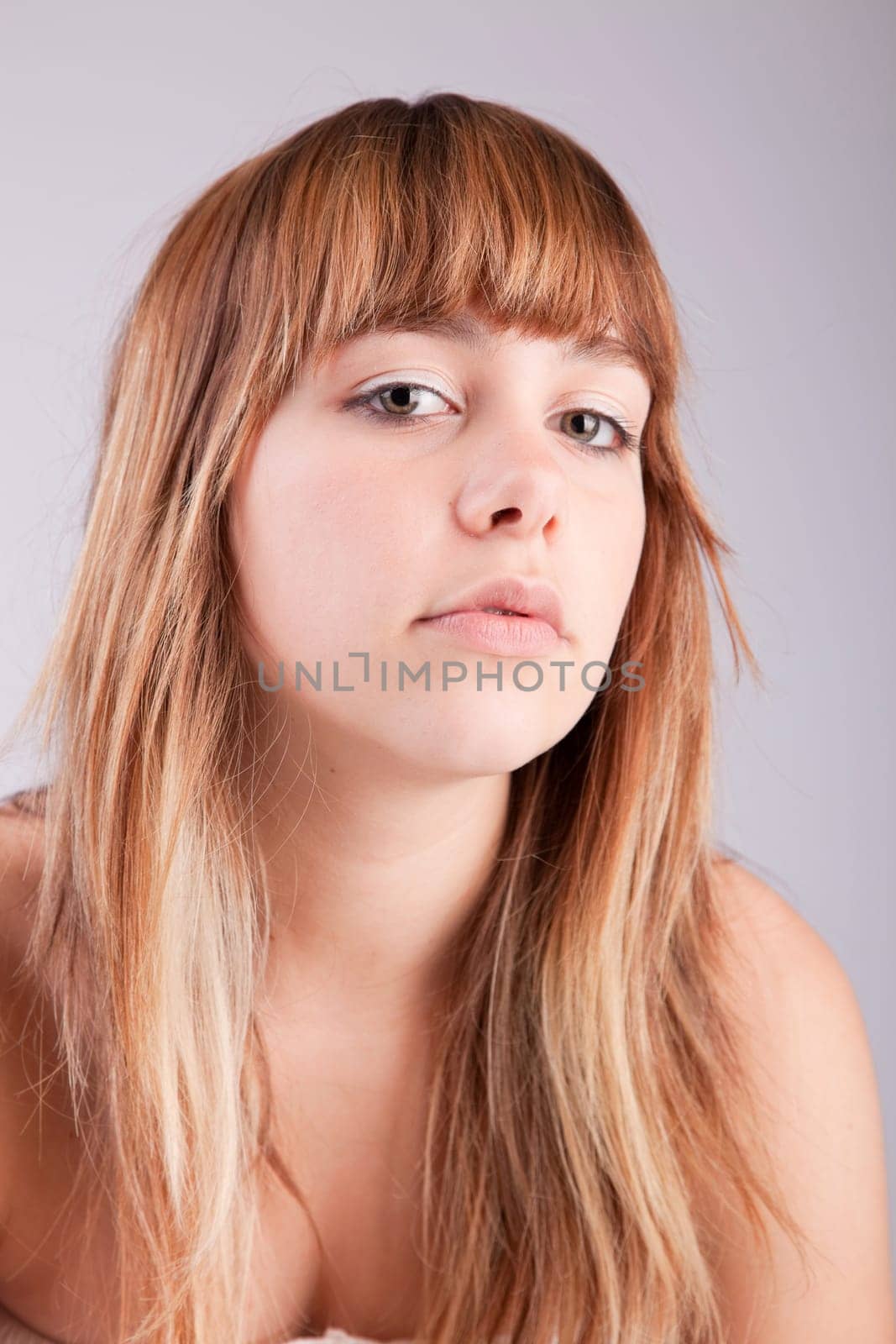 Beautiful woman posing, isolated over grey background