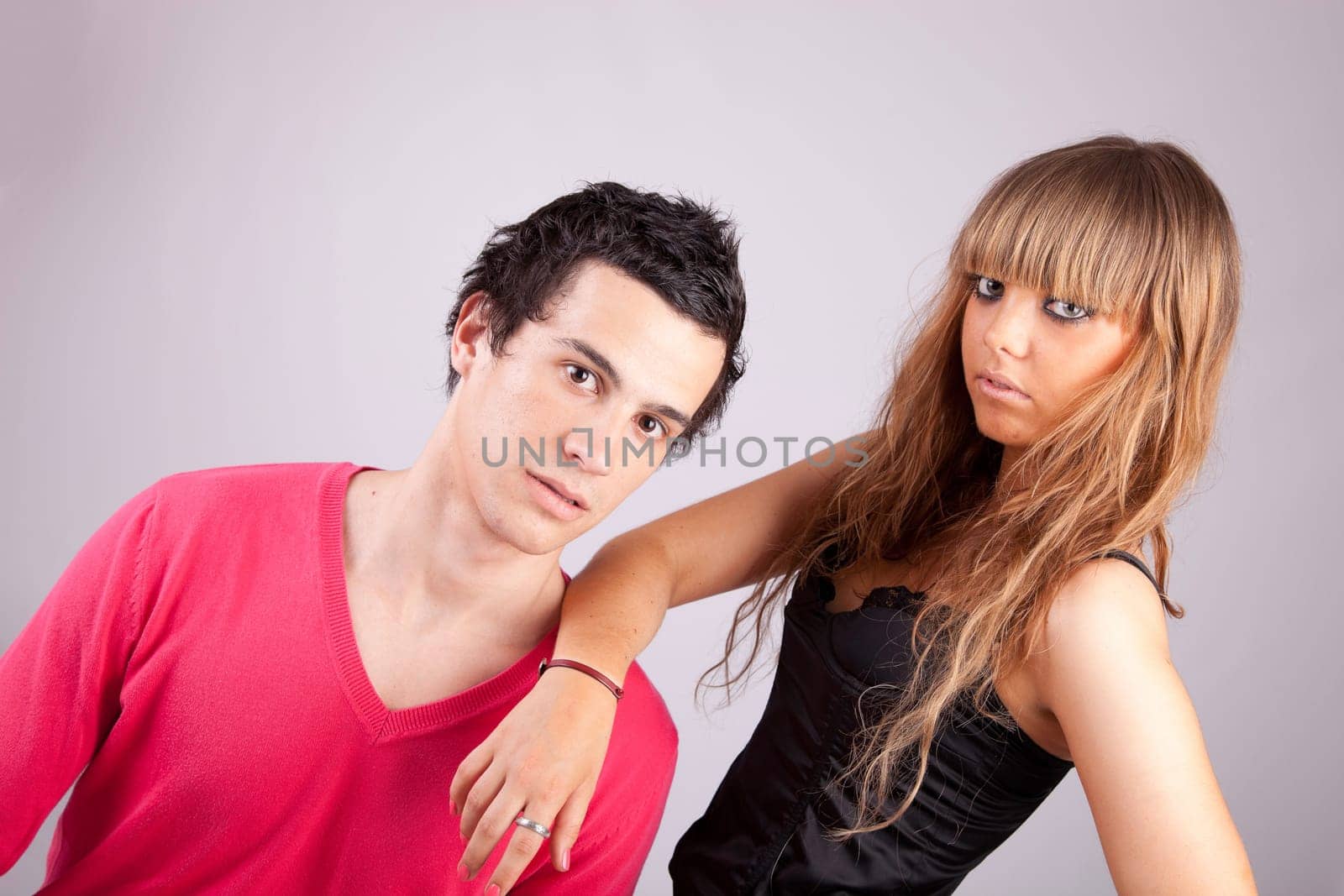 Young casual couple posing isolated